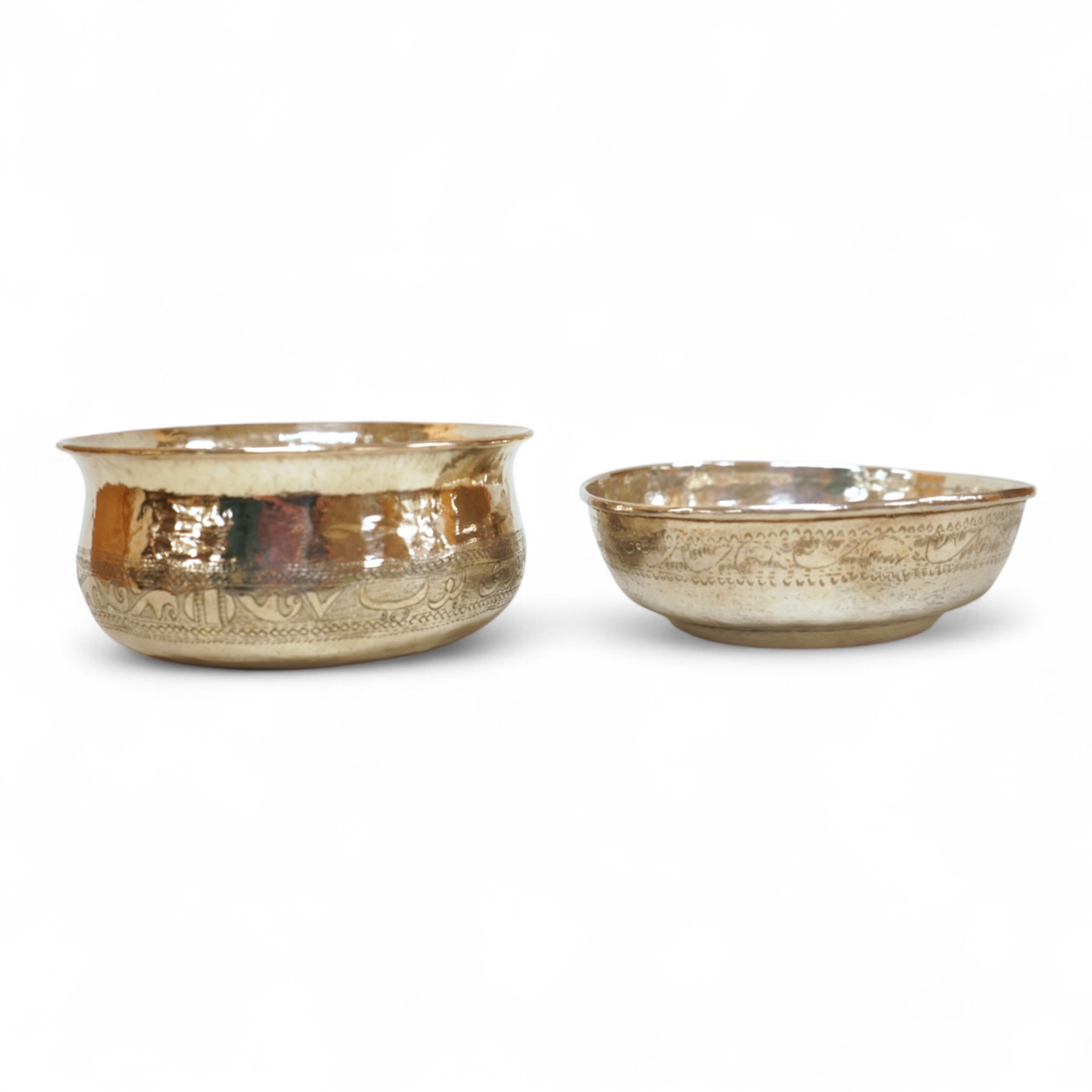 Two early to mid 20th century Persian engraved white metal bowls, both diameters approximately 11.5cm.